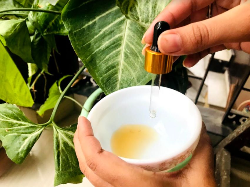 adding tea tree essential oil to the bowl